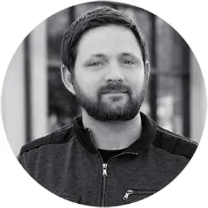 Professional headshot of a team member with creative, energetic vibe in a bright workspace