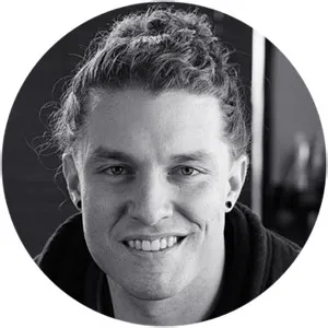 Professional headshot of a team member with a warm, confident smile in a modern office setting